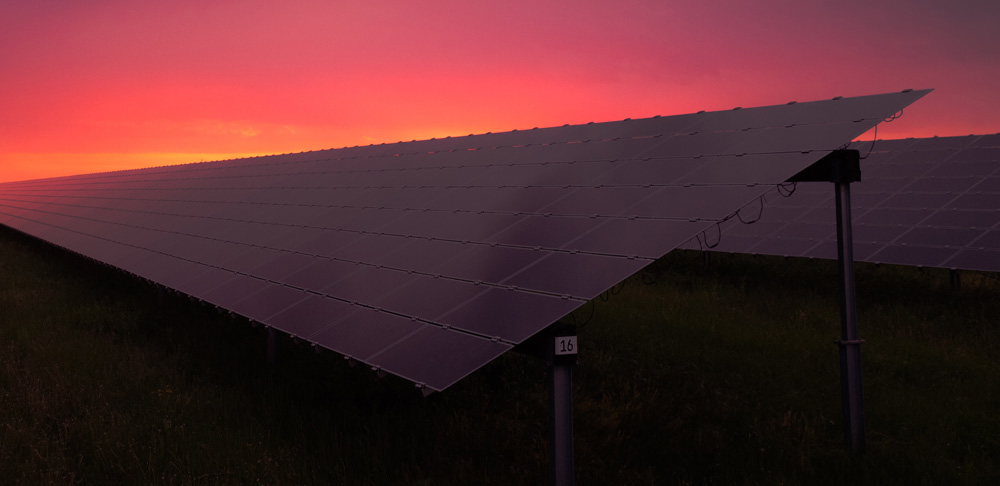 Solar panels against colourful sunset