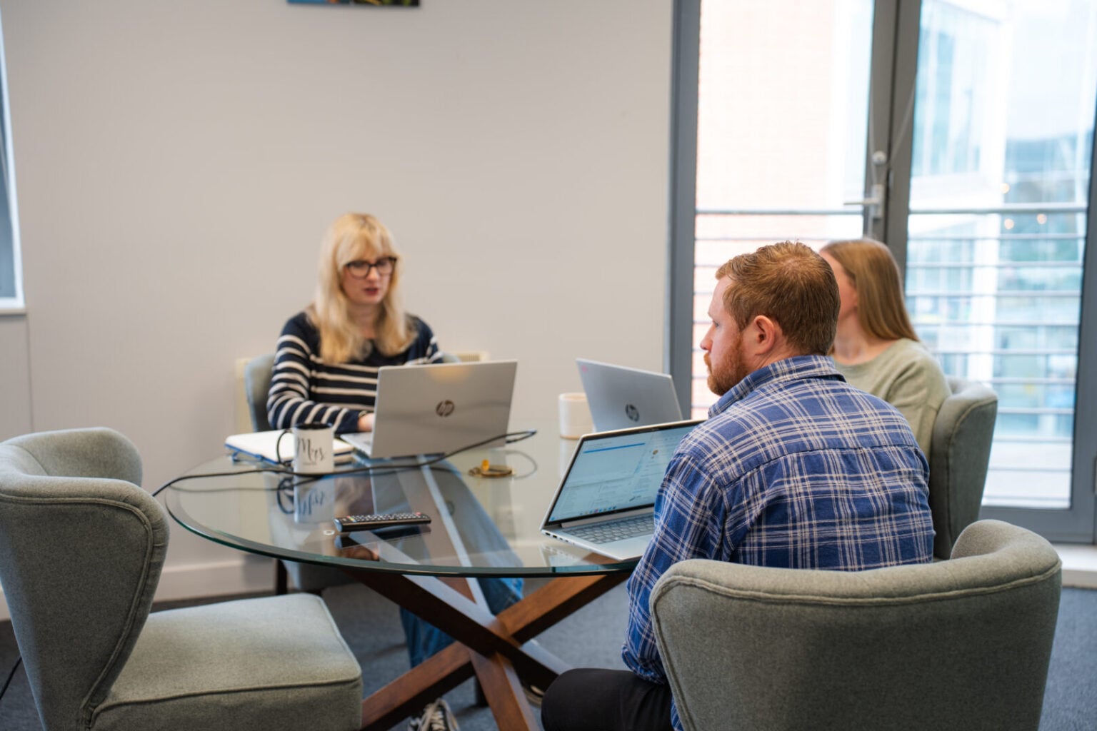 Two women and a man in a meeting
